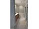 Bright bathroom featuring a double vanity with wood cabinets, a soaking tub, and neutral carpet at 203 Collierstown Way, Peachtree City, GA 30269