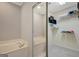 Bathroom with double vanity, large mirror, soaking tub, and walk-in closet at 203 Collierstown Way, Peachtree City, GA 30269