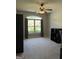 Bedroom featuring neutral carpet, a ceiling fan, and a large window at 203 Collierstown Way, Peachtree City, GA 30269