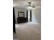 Spacious bedroom featuring neutral carpet, a ceiling fan, and a dark dresser with a large mirror at 203 Collierstown Way, Peachtree City, GA 30269
