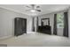 Spacious bedroom featuring neutral carpet, ceiling fan, and a dark wood dresser with matching mirror at 203 Collierstown Way, Peachtree City, GA 30269
