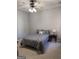 Bedroom featuring neutral carpet and a bed with a gray comforter set at 203 Collierstown Way, Peachtree City, GA 30269