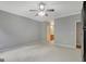 Neutral bedroom with carpet, ceiling fan, and open view to en-suite bathroom at 203 Collierstown Way, Peachtree City, GA 30269