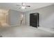 Neutral bedroom featuring carpet, ceiling fan, and a dark wood armoire for ample storage at 203 Collierstown Way, Peachtree City, GA 30269