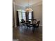Bright dining room featuring chandelier, hardwood floors, and ample natural light from large windows at 203 Collierstown Way, Peachtree City, GA 30269