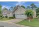 Home exterior featuring a two-car garage, tasteful landscaping, and a concrete driveway at 203 Collierstown Way, Peachtree City, GA 30269