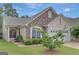 Charming home exterior with stone accents, two-car garage and a well manicured lawn at 203 Collierstown Way, Peachtree City, GA 30269