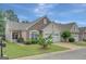Exterior view of a well-maintained home, with a two-car garage, manicured lawn and stone facade at 203 Collierstown Way, Peachtree City, GA 30269