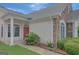Inviting front porch with stone accents, lush landscaping, and a red front door at 203 Collierstown Way, Peachtree City, GA 30269