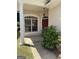 Inviting front porch with a large window, red front door, and a column on the left at 203 Collierstown Way, Peachtree City, GA 30269