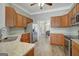 Well-lit kitchen with stainless steel appliances, granite countertops, and wood cabinetry at 203 Collierstown Way, Peachtree City, GA 30269
