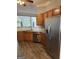Well-equipped kitchen featuring stainless steel appliances, wood cabinets, and granite countertops at 203 Collierstown Way, Peachtree City, GA 30269