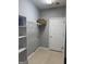 Laundry room featuring tile flooring, shelving, and a door at 203 Collierstown Way, Peachtree City, GA 30269