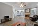 Bright living room featuring a fireplace, hardwood floors, and comfortable seating at 203 Collierstown Way, Peachtree City, GA 30269