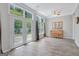 Bright living room with hardwood floors, piano, and French doors leading to the patio at 203 Collierstown Way, Peachtree City, GA 30269