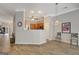 Open-concept living space featuring modern decor, hardwood floors, and stylish lighting fixtures at 203 Collierstown Way, Peachtree City, GA 30269