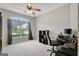 Well-lit office area with carpet, ceiling fan, large window, and black desk at 203 Collierstown Way, Peachtree City, GA 30269