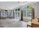 Bright sunroom with hardwood floors, large windows and comfortable wicker furniture at 203 Collierstown Way, Peachtree City, GA 30269