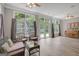 Bright sunroom with hardwood floors, large windows and comfortable wicker furniture at 203 Collierstown Way, Peachtree City, GA 30269