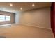 Spacious basement area with a large window, carpet flooring, and recessed lighting at 6205 Collingham Trce, Cumming, GA 30040