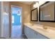 Bathroom featuring double sinks, marble countertop, and white cabinetry at 6205 Collingham Trce, Cumming, GA 30040