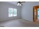 Bedroom includes a ceiling fan, a window and neutral carpeting at 6205 Collingham Trce, Cumming, GA 30040