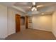 Carpeted room features ceiling fan, recessed lights, built in shelving and wood double doors at 6205 Collingham Trce, Cumming, GA 30040