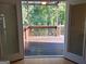 View of wooden deck through open doors with wooded area beyond at 6205 Collingham Trce, Cumming, GA 30040