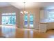 Dining area featuring hardwood floors, large windows, and doors leading to an outdoor deck at 6205 Collingham Trce, Cumming, GA 30040