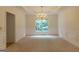 Formal dining room featuring carpet, chair railing, modern chandelier and large window at 6205 Collingham Trce, Cumming, GA 30040