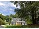 Charming two-story home with shutters, front porch, manicured lawn, and mature trees at 6205 Collingham Trce, Cumming, GA 30040