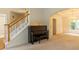 Foyer showcasing a piano next to staircase and entrance to the dining room with elegant trim at 6205 Collingham Trce, Cumming, GA 30040