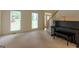 Foyer featuring staircase, piano and light-filled windows offering natural light at 6205 Collingham Trce, Cumming, GA 30040