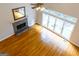 Bright living room with fireplace, hardwood floors, and large windows at 6205 Collingham Trce, Cumming, GA 30040