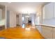 Open concept living room with fireplace, hardwood floors and views to the kitchen and dining area at 6205 Collingham Trce, Cumming, GA 30040