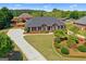Brick home with mature landscaping, circular driveway, and a well-maintained lawn at 130 Gillson Dr, Mcdonough, GA 30253