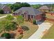 Expansive aerial view of a brick home with lush landscaping and circular driveway at 130 Gillson Dr, Mcdonough, GA 30253