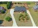 Aerial view of a brick home with mature landscaping, circular driveway, and a well-manicured lawn at 130 Gillson Dr, Mcdonough, GA 30253
