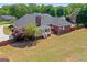 Aerial view of a brick home with a well-maintained yard, screened porch and mature trees at 130 Gillson Dr, Mcdonough, GA 30253