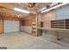 Basement area featuring a garage door, workbench, and shelving for storage and projects at 130 Gillson Dr, Mcdonough, GA 30253