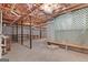 Unfinished basement featuring exposed pipes, concrete floors, and a support beam at 130 Gillson Dr, Mcdonough, GA 30253