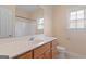 Bathroom featuring a vanity with a light countertop, wooden cabinets, and a large mirror at 130 Gillson Dr, Mcdonough, GA 30253
