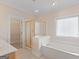 Bathroom with soaking tub, glass shower, and walk-in closet at 130 Gillson Dr, Mcdonough, GA 30253