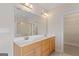 Bathroom with double sink vanity, large mirror and a door to the walk-in closet at 130 Gillson Dr, Mcdonough, GA 30253