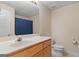 Bathroom featuring a vanity with a light countertop, wooden cabinets, and a large mirror at 130 Gillson Dr, Mcdonough, GA 30253
