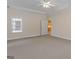 Large, carpeted primary bedroom with a ceiling fan and natural light at 130 Gillson Dr, Mcdonough, GA 30253