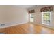 Cozy bedroom with hardwood floors, large windows, and decorative window treatments at 130 Gillson Dr, Mcdonough, GA 30253