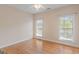 Bedroom showcasing hardwood floors, neutral walls, two windows, and a ceiling fan at 130 Gillson Dr, Mcdonough, GA 30253