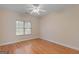 Empty bedroom featuring hardwood floors, neutral paint, a ceiling fan, and ample light at 130 Gillson Dr, Mcdonough, GA 30253