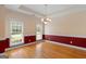 Charming dining room features rich wood flooring and a stylish chandelier at 130 Gillson Dr, Mcdonough, GA 30253